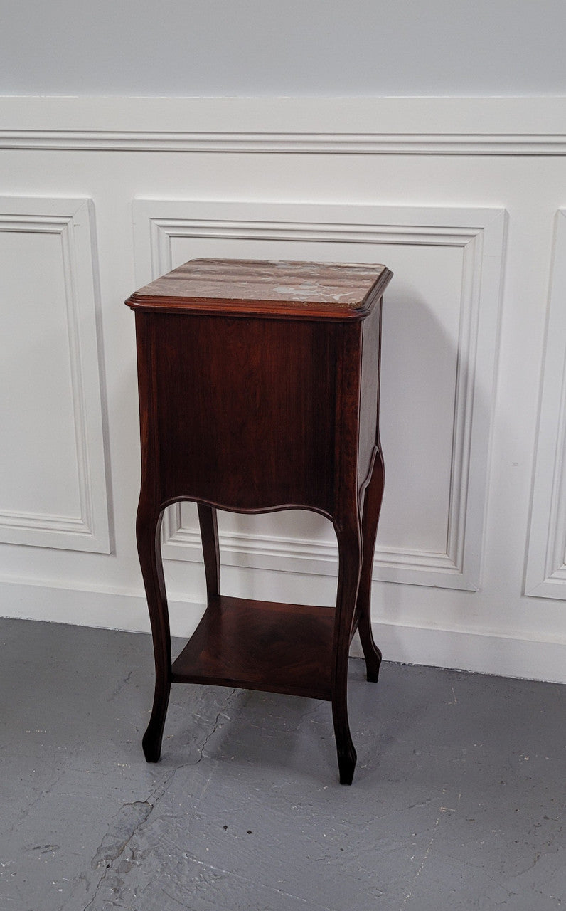 French Rosewood inset marble top single bedside cabinet with one drawer and one cupboard on elegant legs. Would also make a practical and stunning table lamp. It is in good original detailed condition.