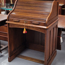 Charming petite English Oak fitted roll top desk. It has a very lovely fitted interior and a drawer at the front ideal for a unit or apartment. Sourced locally and in good original detailed condition.
