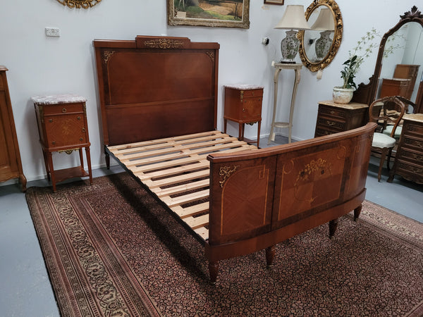 A high quality French Louis XV style bow fronted Queen size bed with marquetry inlay and ormolu mounts. In good original detailed condition. Circa: 1920