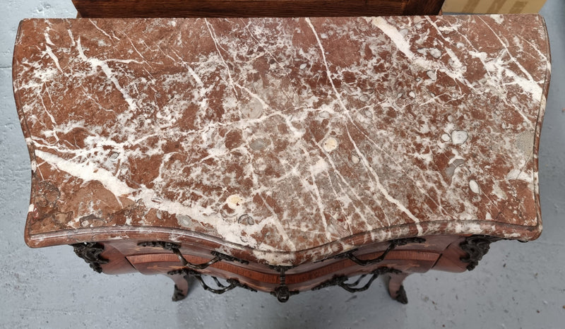 Antique French Louis XV style compact three drawer marble top commode with marquetry inlay and ormolu mounts. Sourced from France and in good original detailed condition.