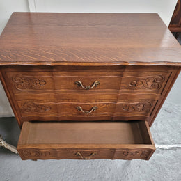 French Oak Louis XV style three drawer commode. It has been sourced from France and has decorative handles and carvings. It is in good original detailed condition.