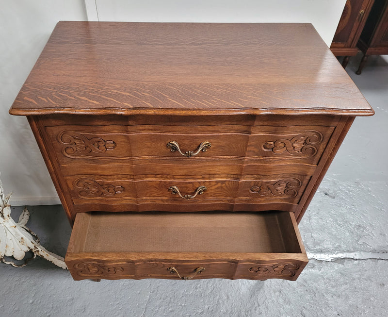 French Oak Louis XV style three drawer commode. It has been sourced from France and has decorative handles and carvings. It is in good original detailed condition.