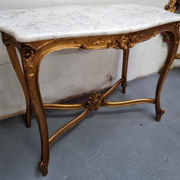 French Louis XV style carved center table with a stunning marble top and original gilt. In good original detailed condition.