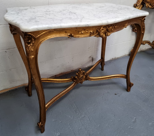 French Louis XV style carved center table with a stunning marble top and original gilt. In good original detailed condition.