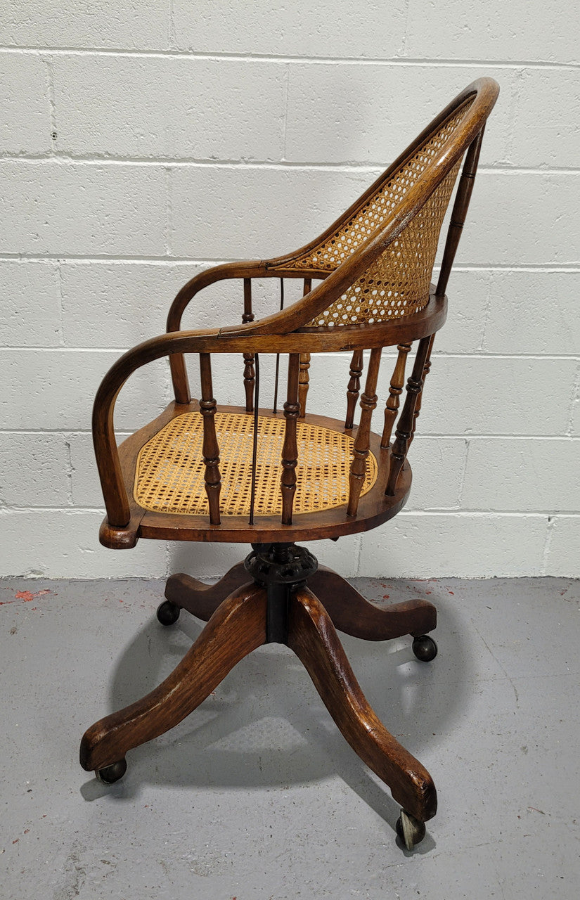 Elm Bentwood and cane swivel desk chair. In good original detailed condition and is comfortable to sit in.