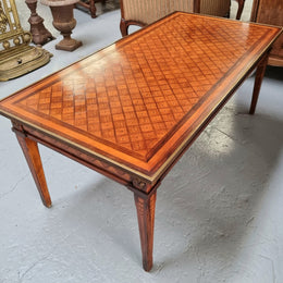 Beautiful French Louis XVI style inlaid coffee table with a brass band and glass top. In good original detailed condition.