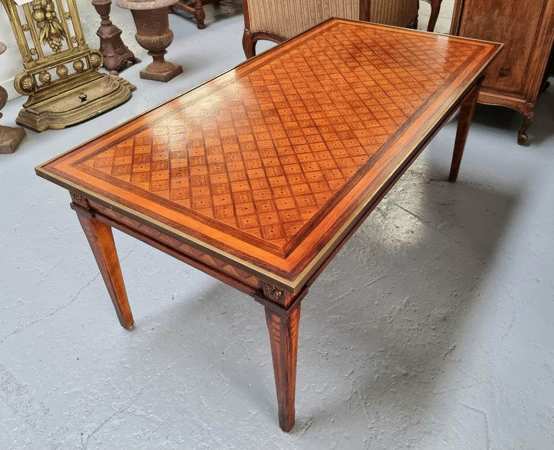 Beautiful French Louis XVI style inlaid coffee table with a brass band and glass top. In good original detailed condition.