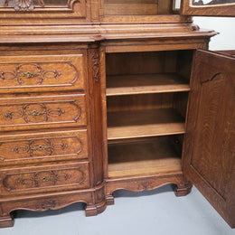 Impressive French Oak Louis 14th Style Display and Sideboard. It has 4 drawers, 2 bottom cupboards with 6 total shelves and 3 display doors with 3 shelves.  In good, detailed condition.
