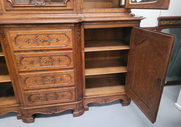Impressive French Oak Louis 14th Style Display and Sideboard. It has 4 drawers, 2 bottom cupboards with 6 total shelves and 3 display doors with 3 shelves.  In good, detailed condition.