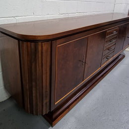 Amazing French Walnut Art deco four door buffet. The doors either side open to a fixed shelf and plenty of added storage with four drawers. In good original detailed condition.