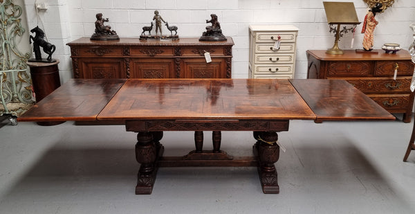 Renaissance style Oak extension table with parquetry top and twin pedestal base. The table extends by pulling out an extension leaf either side making it 287 cm long. Sourced from France and in good original detailed condition.