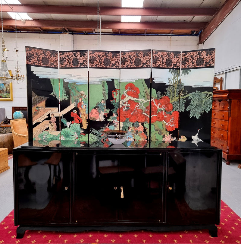 French Art Deco sideboard with a custom black lacquer finish.  Beautiful serpent shaped front with four cupboards with working locks and includes to working keys. It is in original condition.