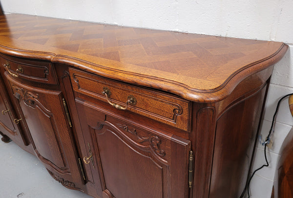 French Oak Louis XV style three drawer three door parquetry top sideboard. It has been sourced from France and is in good original detailed condition.