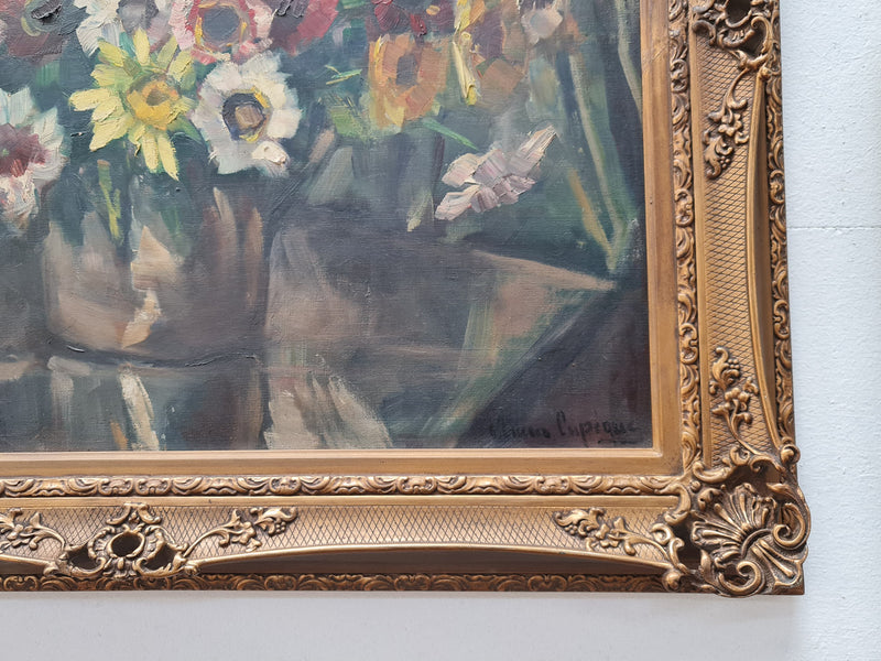 Sourced in France is this beautiful floral oil painting on canvas and framed in a lovely decorative frame. It is in good original condition.