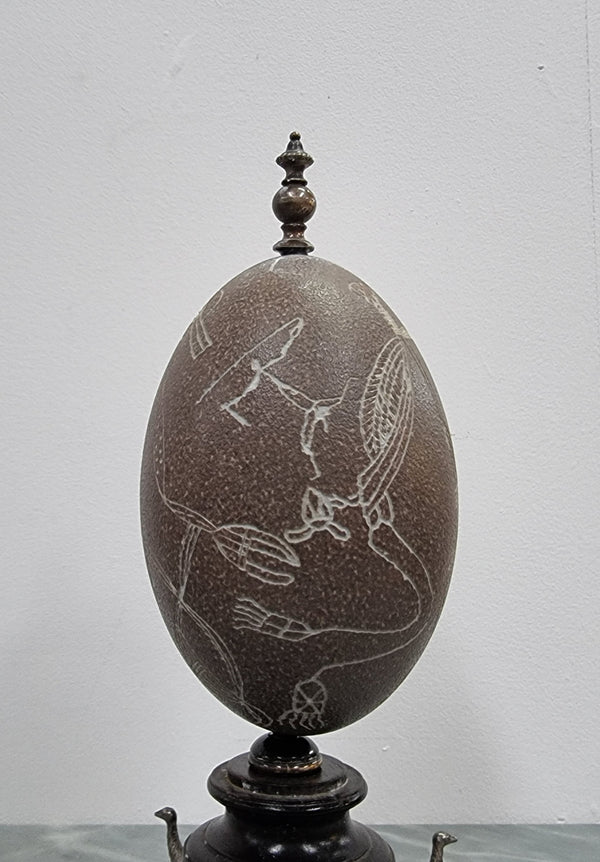 Superbly carved Emu egg on a emu metal and ebony base. It depicts an Aboriginal hunting scene and dreaming's. It is in good original condition, please view photos as they help form part of the description.