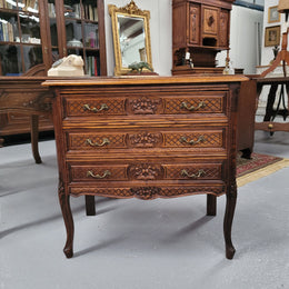 Rustic Louis XV style Oak petite three drawer chest featuring attractive carvings. It has been sourced locally and it is in good original detailed condition.