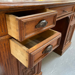 Lovely French Oak carved desk with four drawers and two cupboards. It is in good original detailed condition.