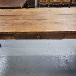 Provincial 19th Century French Oak rustic farmhouse table with tapered leg and single drawer. It has been sourced from France and is in good original detailed condition. 
