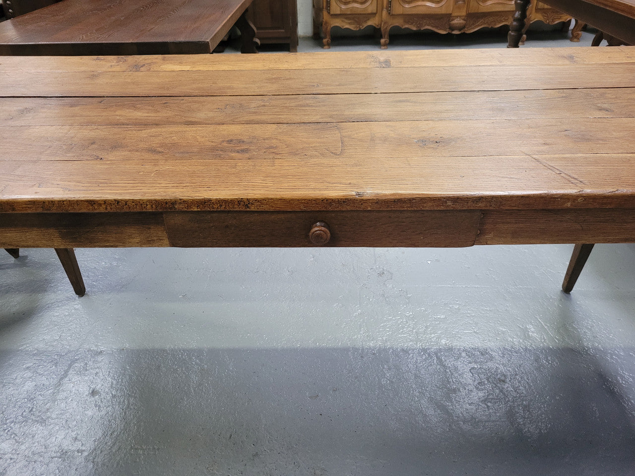 Provincial 19th Century French Oak rustic farmhouse table with tapered leg and single drawer. It has been sourced from France and is in good original detailed condition. 