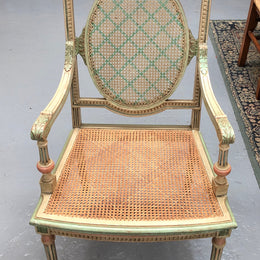 Painted French Louis XVI style cane panel arm chair. Paint is original and it is in very good original condition.