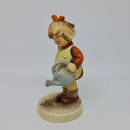 Gorgeous Hummel girl with watering can figurine, marked #74 . In great original condition.