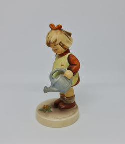 Gorgeous Hummel girl with watering can figurine, marked #74 . In great original condition.