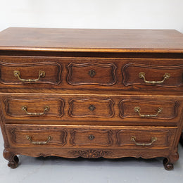 French Provincial Oak three drawer wooden top commode. It has elegant carvings and handles. It has been sourced from France and is in good original detailed condition.