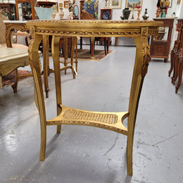 Impressive French oval Louis XVI style gilt and white marble topped two tier lamp/side table. It has been sourced from France and is in good original detailed condition.