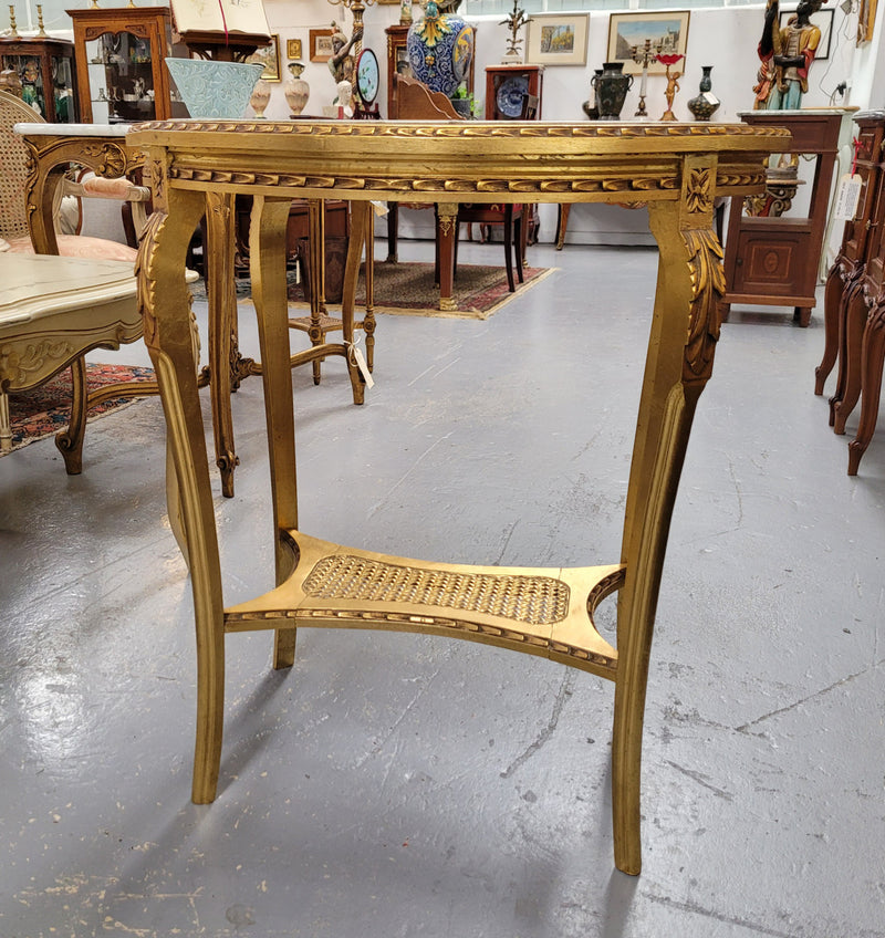 Impressive French oval Louis XVI style gilt and white marble topped two tier lamp/side table. It has been sourced from France and is in good original detailed condition.