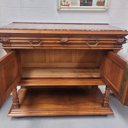 Stunning Henry II style French Walnut marble top buffet. It has a beautiful marble top and plenty of storage with two drawers, two doors with beautiful decorative carvings and an open shelf. It has been sourced from France and is in good original condition and has been detailed to a high standard.