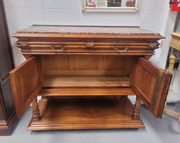 Stunning Henry II style French Walnut marble top buffet. It has a beautiful marble top and plenty of storage with two drawers, two doors with beautiful decorative carvings and an open shelf. It has been sourced from France and is in good original condition and has been detailed to a high standard.