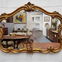 French Louis XV style wood carved and gilded mirror. Mirror is original and showing signs of age. It has been sourced from France and  in good original condition.