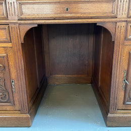 Lovely French Oak carved desk with four drawers and two cupboards. It is in good original detailed condition.