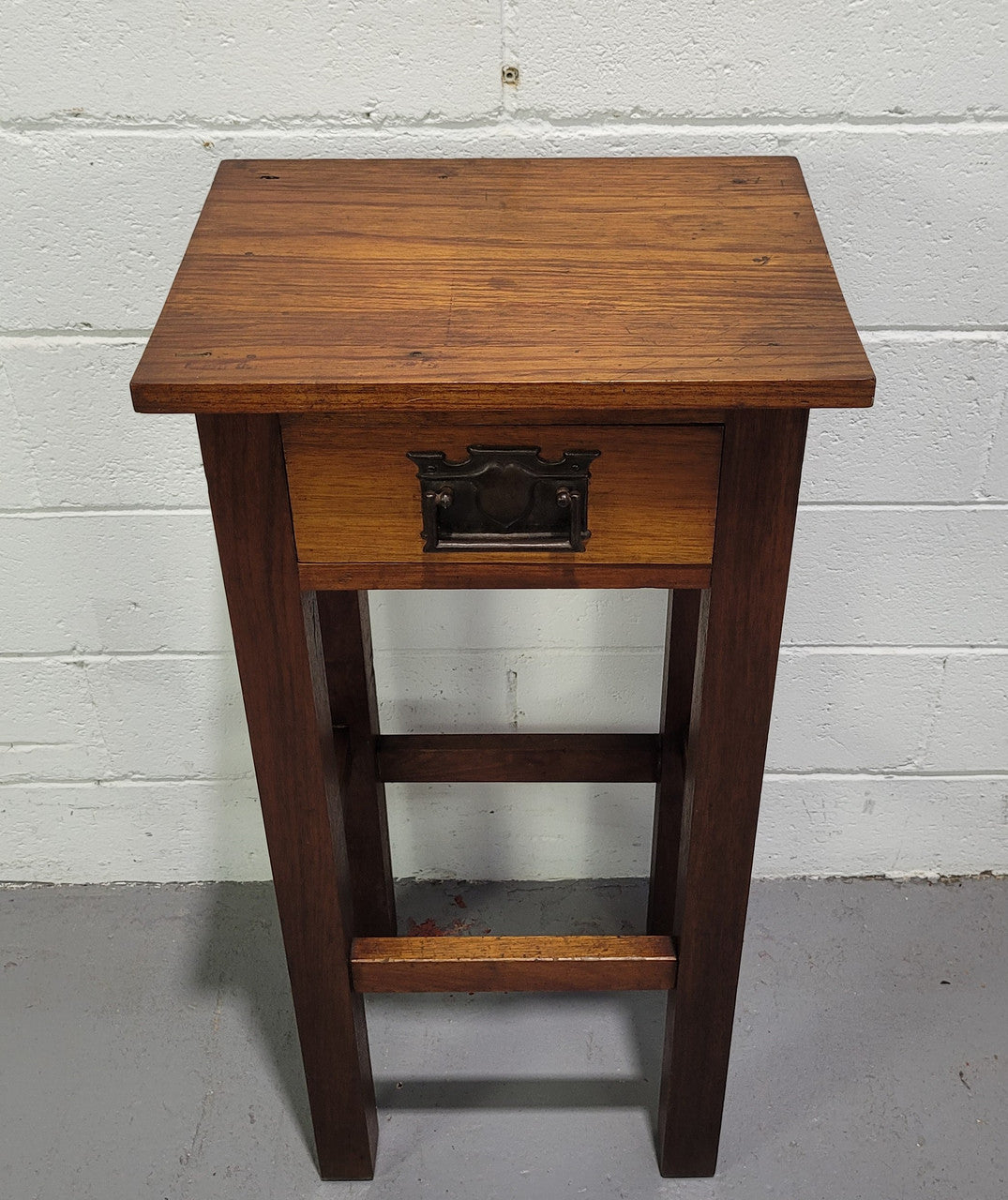Small Arts and Crafts side table/bedside table. With drawer and is in good original detailed condition.