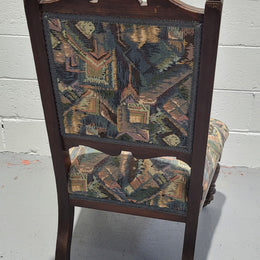 Single upholstered Edwardian nursing chair. Fabric is in good original used condition and chair has four caster wheels and is in good original condition.