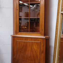 Practical Walnut corner cabinet with display and storage. Two shelf glass display on top and single shelf cupboard below. Sourced locally and in good original detailed condition.