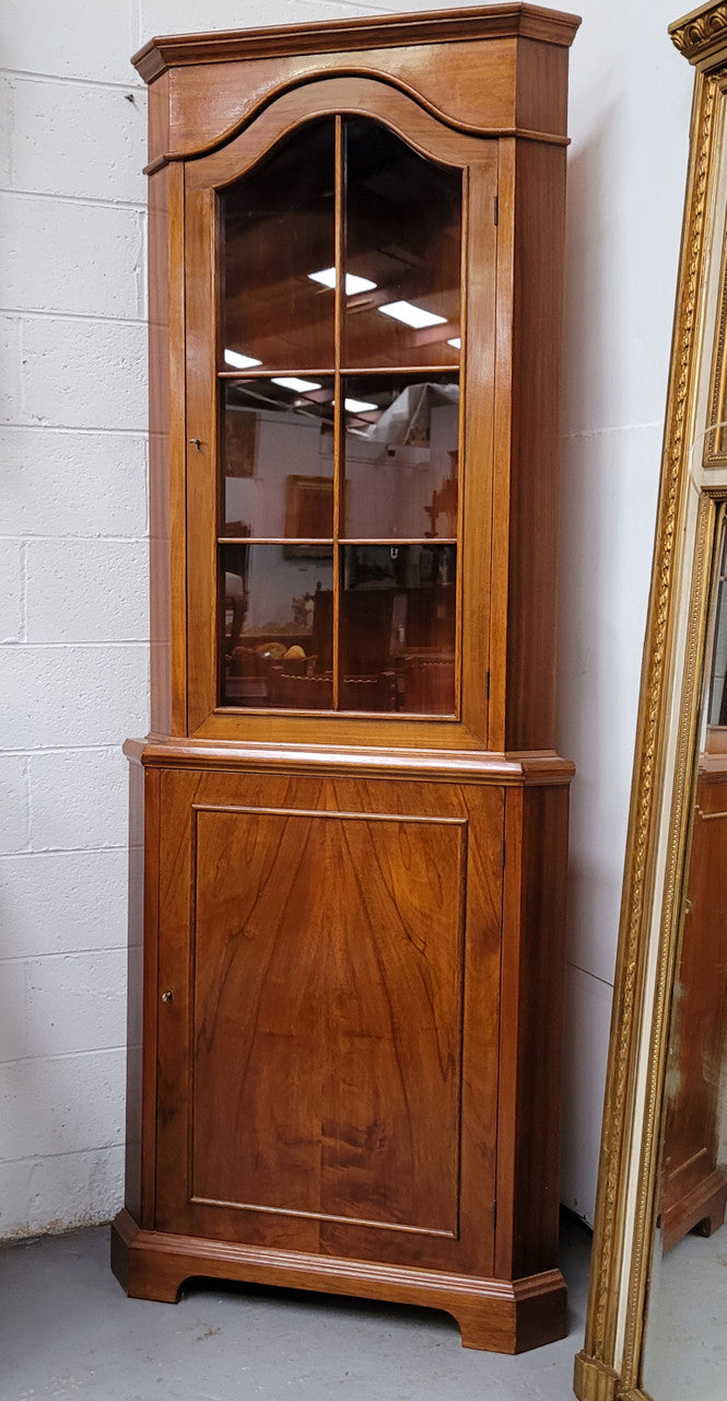 Practical Walnut corner cabinet with display and storage. Two shelf glass display on top and single shelf cupboard below. Sourced locally and in good original detailed condition.
