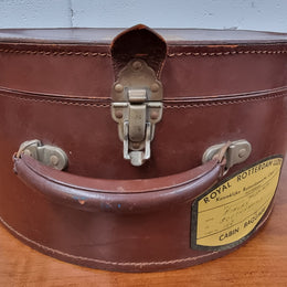 Charming solid leather hatbox with patterned fabric interior and two interior pockets. Interior stamp is for The Mutual Store Melbourne. Bears paper stamps for P&O Cruise Passenger” & “Peninsular  the top and D.M.F. in gold near the handle. Circa: Early 1900’s. 43 cm across and H:21 cm the lid.