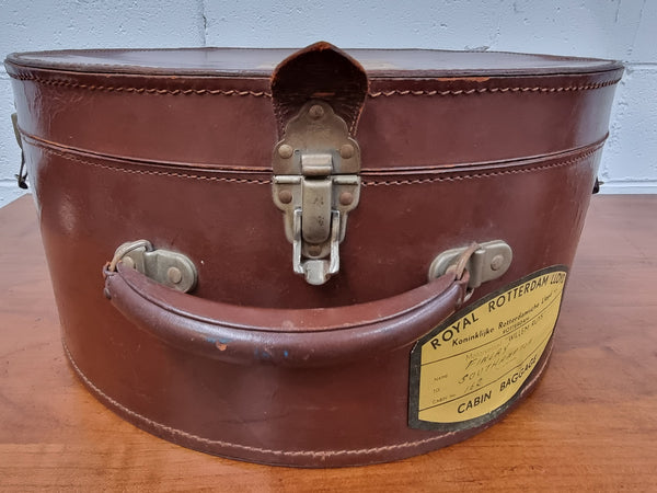 Charming solid leather hatbox with patterned fabric interior and two interior pockets. Interior stamp is for The Mutual Store Melbourne. Bears paper stamps for P&O Cruise Passenger” & “Peninsular  the top and D.M.F. in gold near the handle. Circa: Early 1900’s. 43 cm across and H:21 cm the lid.