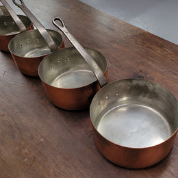 Set of five copper sauce pans with foundry stamp. They have been sourced from France and are in good original detailed condition.