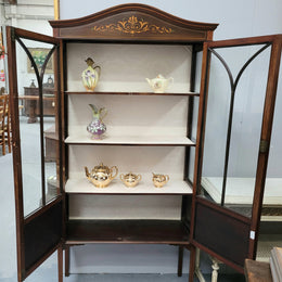 Edwardian Sheraton style display cabinet with hand-painted panels and a good fabric interior. In good original detailed condition.