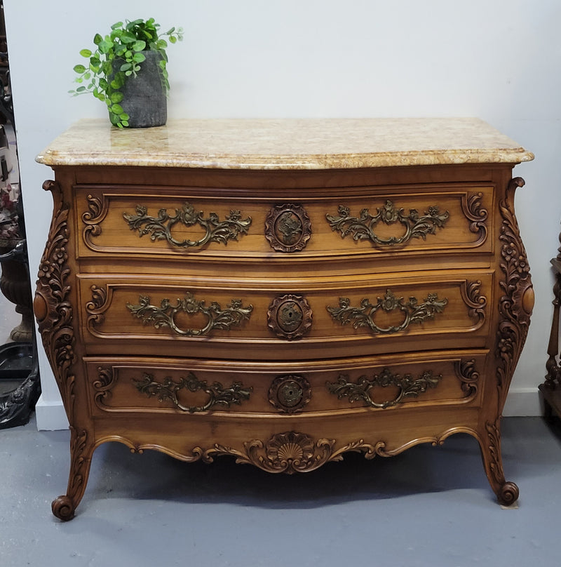 Impressive Louis XV style three drawer walnut commode. Ormolu handles and bevelled marble top complimenting detailed carving. In very good original detailed condition.