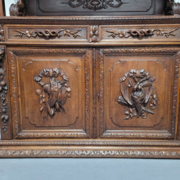 Grand French Oak Gothic style buffet with amazing detailed carvings. This stunning buffet has a display section at the top with two adjustable shelves, two drawers in the middle with elegantly carved handles and storage below with one fixed shelf. It is in good original detailed condition.