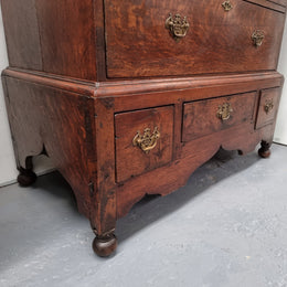 Early 19th Century English Oak chest on stand. It has been sourced in France and has plenty of storage space with eight drawers. In good original detailed condition.