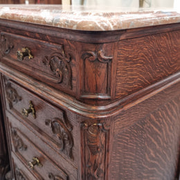 A pair of hard to find French Oak Louis XV style four drawer marble topped bedsides with attractive carvings. They are in good original detailed condition and have been sourced from France.