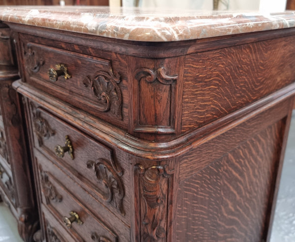 A pair of hard to find French Oak Louis XV style four drawer marble topped bedsides with attractive carvings. They are in good original detailed condition and have been sourced from France.