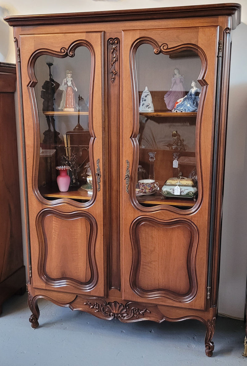 French Walnut Louis XV Style two half glass, door bookcase with three adjustable shelves. Sourced from France and in good original detailed condition.