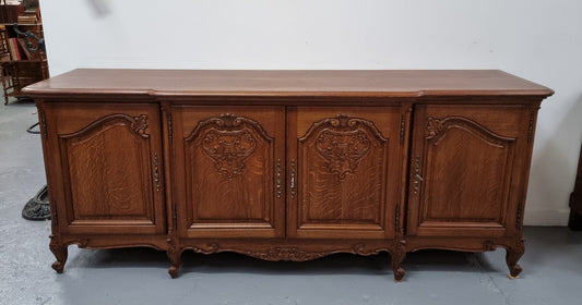 French oak large, beautifully carved four door sideboard with lockable doors and plenty of room for storage in good original condition.