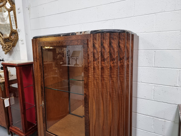 Stunning French Art Deco figured Walnut with Portoro marble top cocktail cabinet. Features chrome trim on base and glass display in door. It is in fully restored condition.