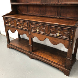 Fabulous Antique Tudor style Oak kitchen dresser with two drawers and two shelves. It is in good original detailed condition.